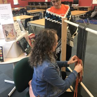 Students trying their hand at weaving