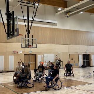 Students & staff trying wheelchair basketball